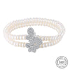 Bracelet fantaisie perles blanches et breloque papillon