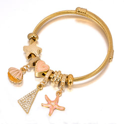 Bracelet fantaisie jonc or breloque plage coquillage